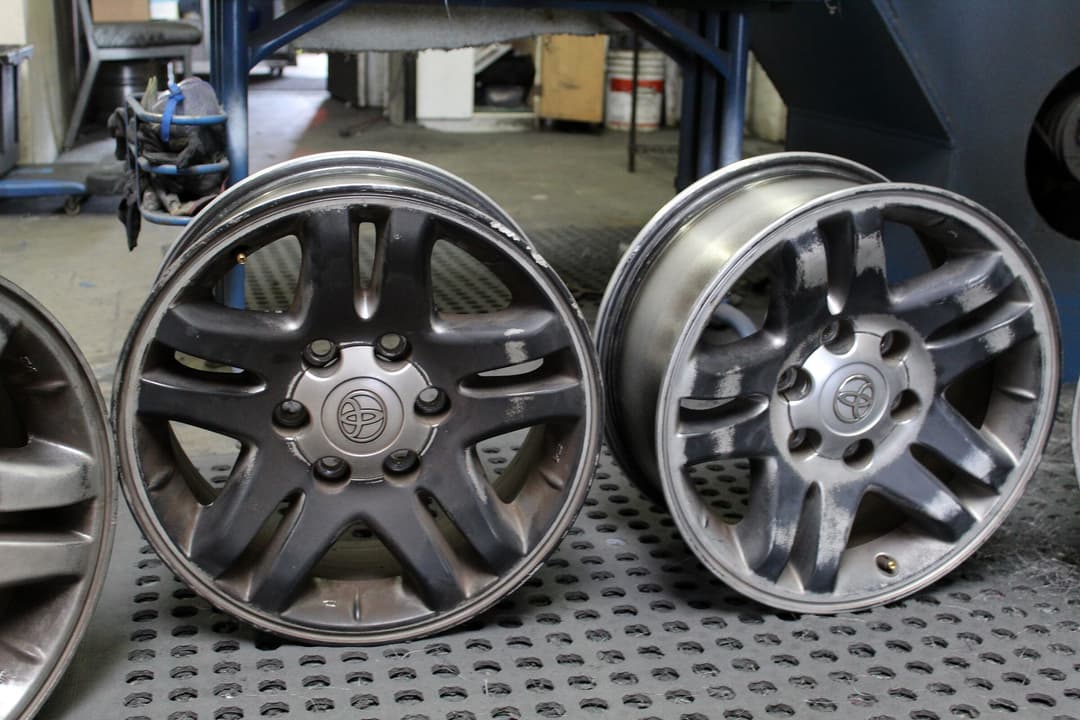 Polished aluminum truck wheels lined up in the shop